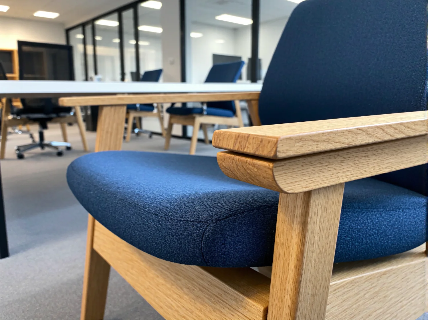 Prosta szara sofa o geometrycznym kształcie idealna do minimalistycznych wnętrz edukacyjnych